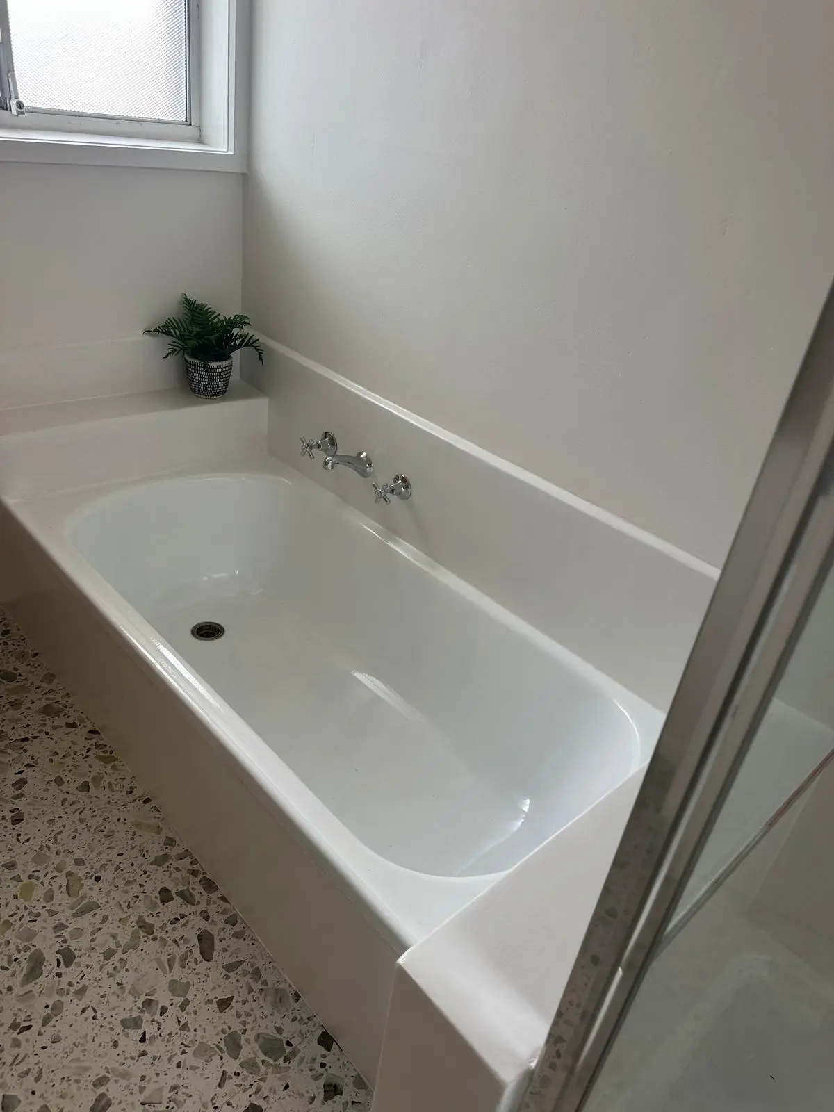 Completed white bathtub and seamless bathroom finish